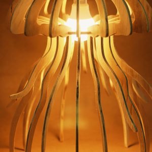 Wooden jellyfish-shaped table lamp glowing warmly