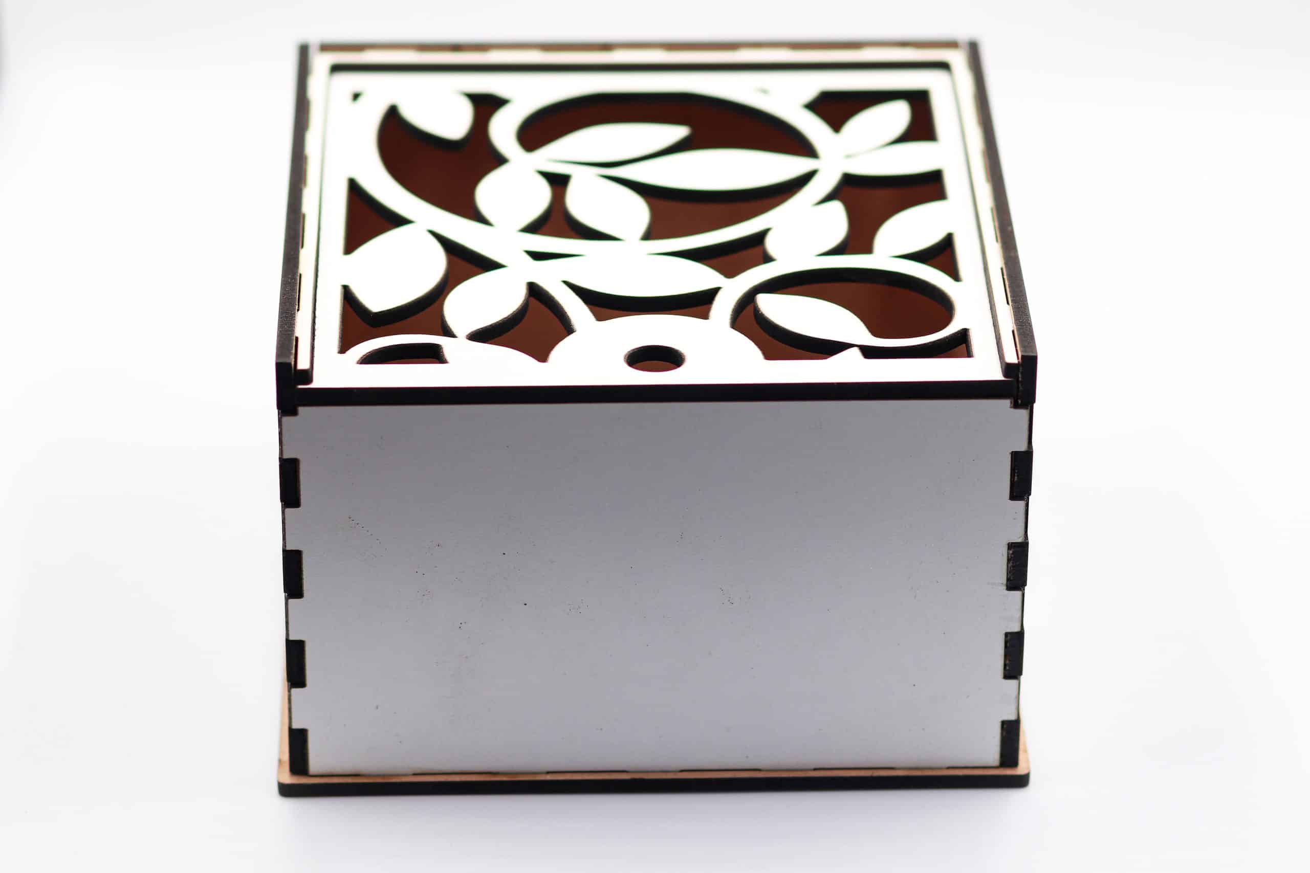 Front view of white wooden gift box with floral laser-cut lid